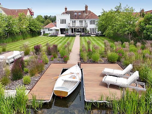 Riverside house garden and mooring. Suffolk Image.